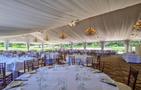 Inside the outdoor tent ballroom set for a spring wedding at West Hills Country Club