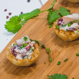 Small bite hors d'oeuvres on a wood platter