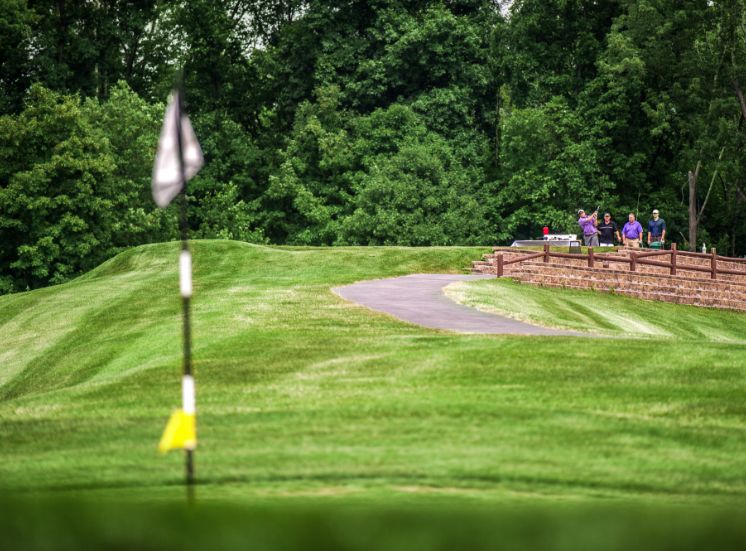 Golf flag waving as golfers tee off