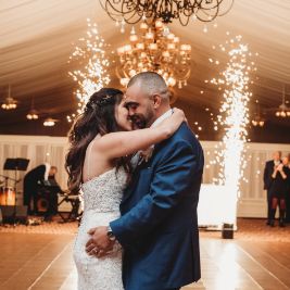 sparkler-tent-Owls Eye Couple dancing and kissing with sparklers behind them in a luxury tent