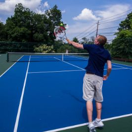 Playing tennis on a blue tennis court