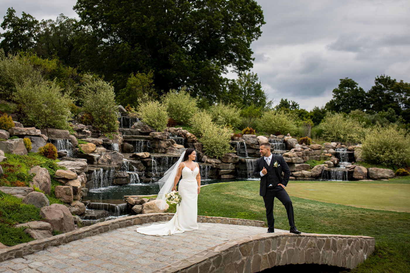 A couple walks on a suspension bridge over the Walkill River at our Hudson Valley Wedding Venue